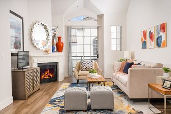 Living room with fireplace and high ceilings